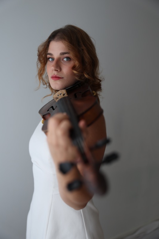 Portrait in a white dress with violin